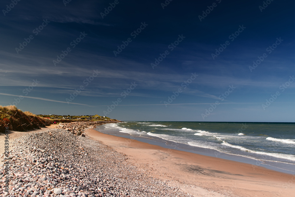 View of the beautiful beach coastline with dunes and stones in Northern Denmark are perfect for summer holidays. Danish Beach, Lønstrup in North Jutland in Denmark, Skagerrak, North Sea View of the beautiful beach coastline with dunes and stones in Northern Denmark are perfect for summer holidays. Danish Beach, Lønstrup in North Jutland in Denmark, Skagerrak, North Sea