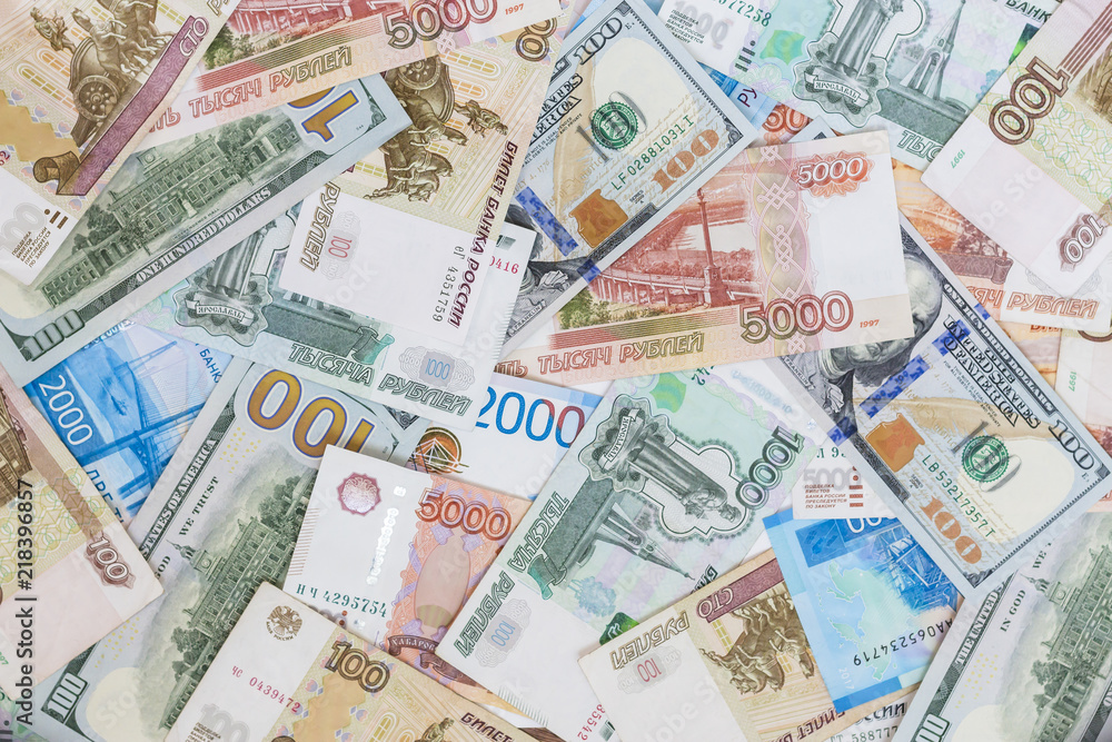 Dollars and Russian rubles banknotes. Business concept International currencies background. Dollars and Russian rubles banknotes. Business concept International currencies background.