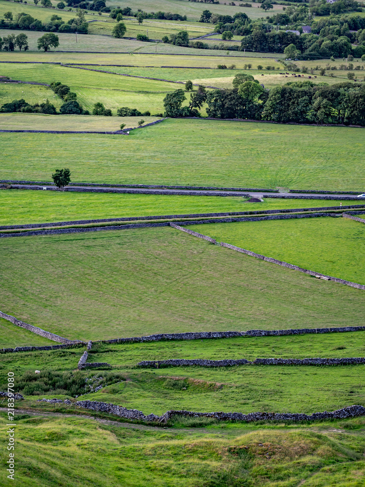 Hilly landscape in the Peak District in the UK with stone fences