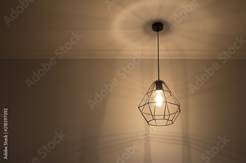 Black frame chandelier from metal rods with Edison's bulb