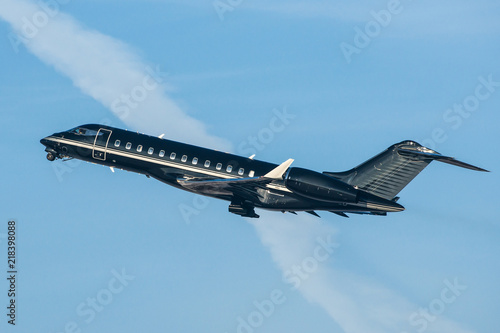 Black modern private business jet taking off