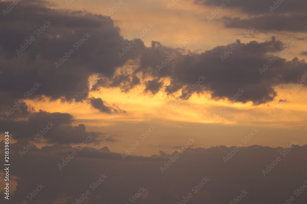 Beautiful sunset with clouds of orange and yellow in the ocean, the river