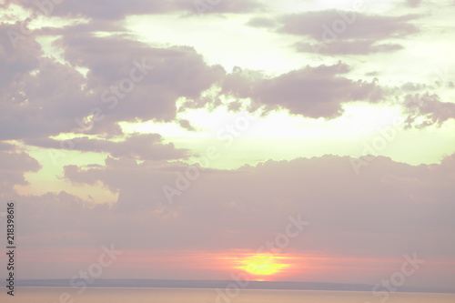 Beautiful sunset with clouds of orange and yellow in the ocean, the river