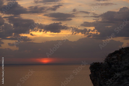 Beautiful sunset with clouds of orange and yellow in the ocean, the river