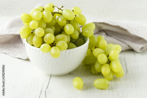 a bunch of grapes on a wooden background