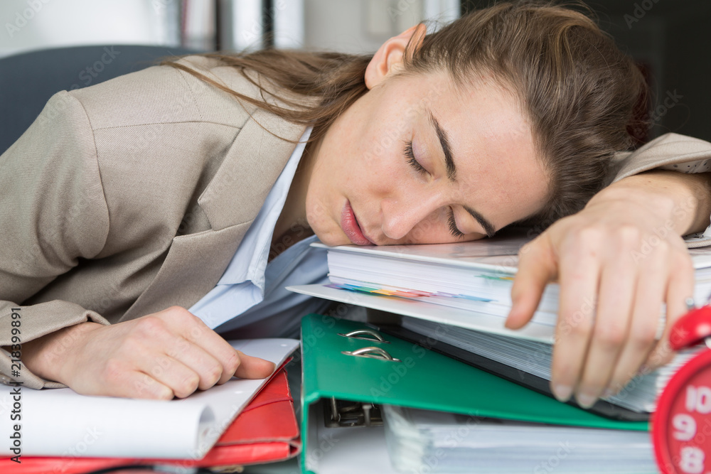 woman having a nap on top of the folders woman having a nap on top of the folders