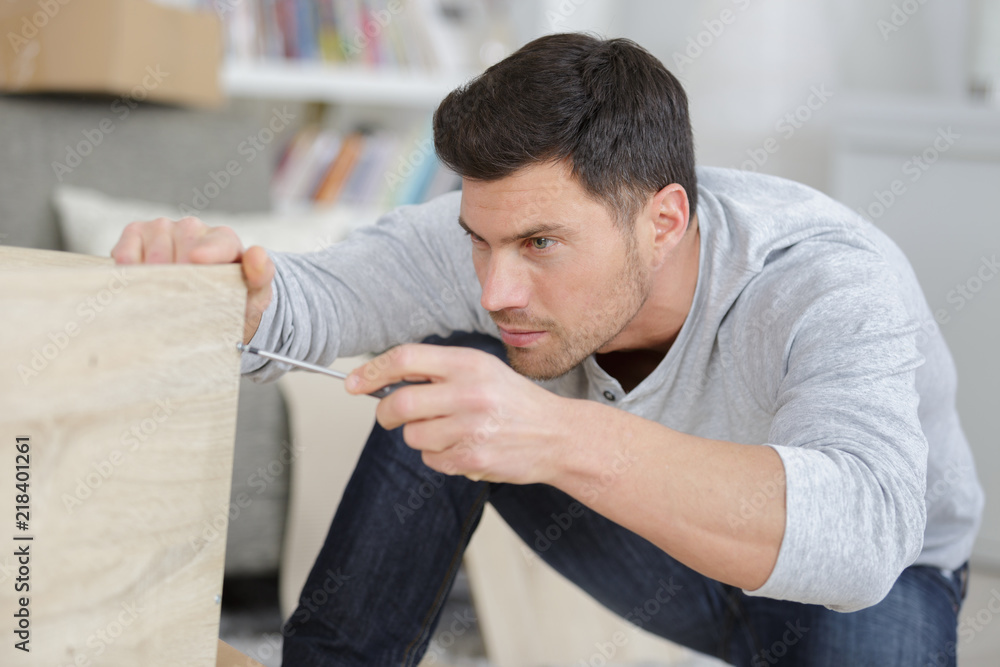 Fototapeta premium man screwing the furniture edges