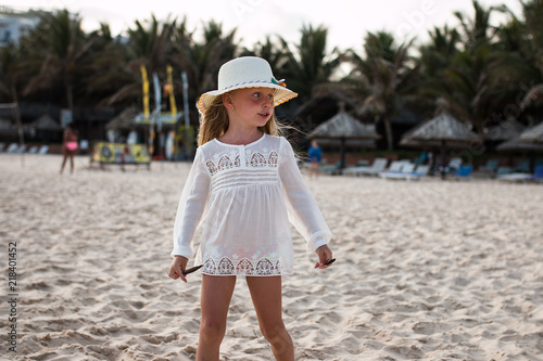 little girl walking on summer tropical beach
