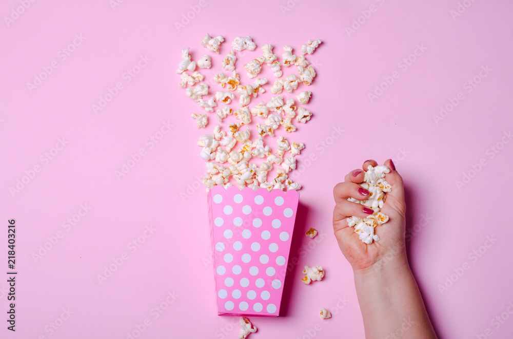 Paper box with popcorn on pink background Paper box with popcorn on pink background