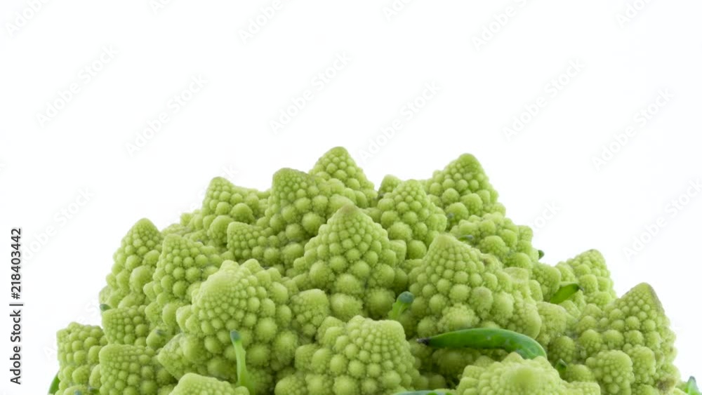 Close-up shooting of upper part of mini romanesco broccoli. Slowly rotating on the turntable isolated on the white background. Close-up. Close-up shooting of upper part of mini romanesco broccoli. Slowly rotating on the turntable isolated on the white background. Close-up.