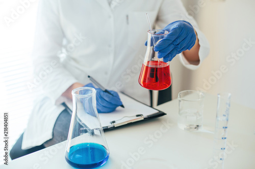 Flask in scientist hand, laboratory work