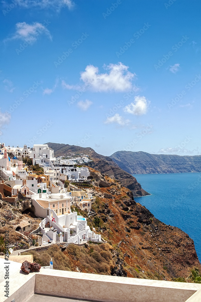 Most Romantic Greek Oia town on Santorini island, Greece. Traditional and famous houses and churches with blue domes over the Caldera, Aegean sea. Santorini classically Thera and officially Thira.