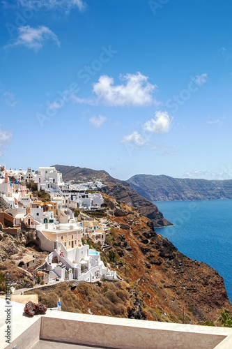 Most Romantic Greek Oia town on Santorini island, Greece. Traditional and famous houses and churches with blue domes over the Caldera, Aegean sea. Santorini classically Thera and officially Thira.