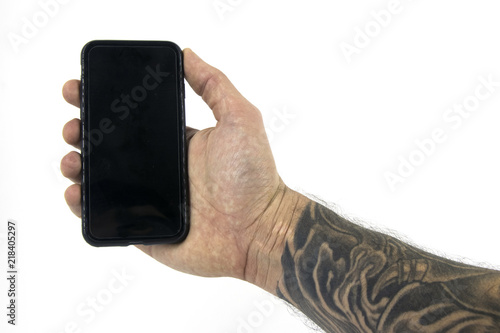 Photography Studio shot with a hand holding a device with forearm tattooed