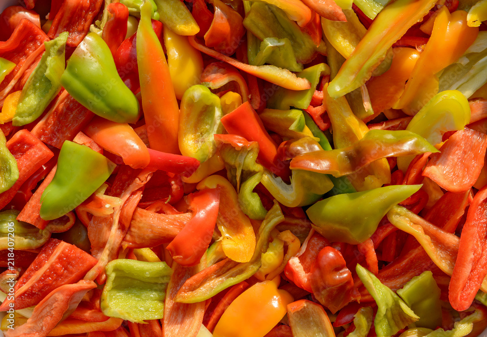 Many pieces of cut-up sweet pepper as bright natural background.