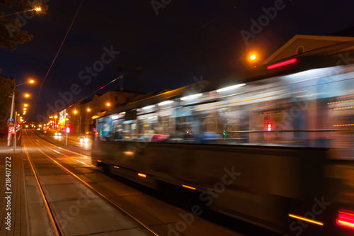 The motion of a blurred tram down the street in the evening. © leon134865