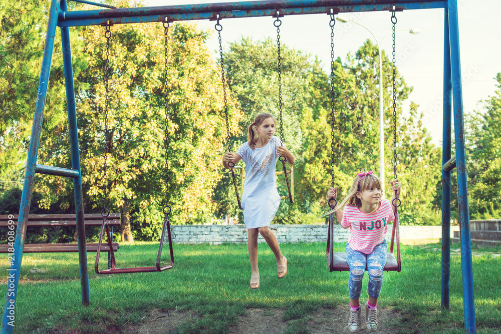 Small girls swinging in the park. Small girls swinging in the park.