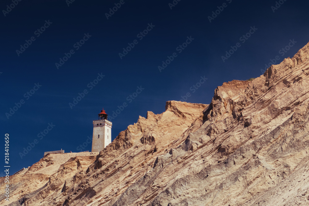 Sand cliffs and sand dunes with the famous lighthouse seen from the danish beach. Rubjerg Knude Lighthouse, Lønstrup and Lokken in North Jutland in Denmark, Skagerrak, North Sea
