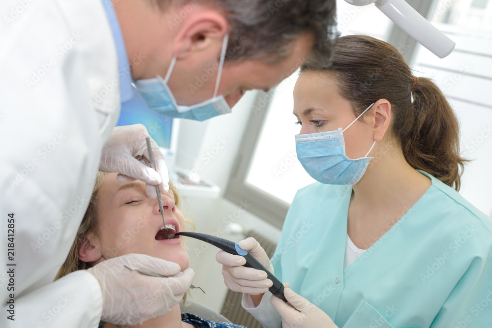 dentist female working with a patient dentist female working with a patient