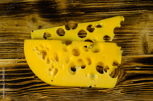 Sliced cheese on wooden table. Top view