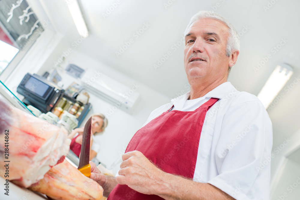 Upward view of butcher holding knife