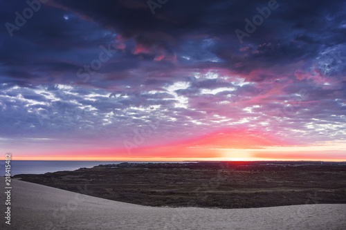 Danish coastline with sand dunes landscape at a dramatic colorful dawn morning sunrise with the ocean. Rubjerg Knude Lighthouse, Lønstrup in North Jutland in Denmark, Skagerrak, North Sea © Ricardo