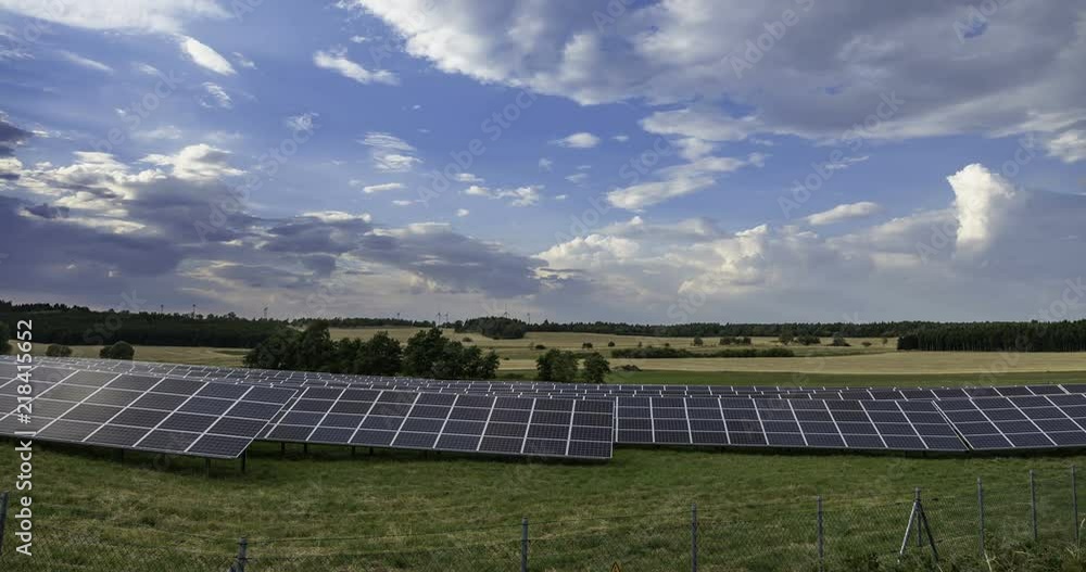 power generating wind turbines and modern solar panels in the countryside (time lapse) power generating wind turbines and modern solar panels in the countryside (time lapse)