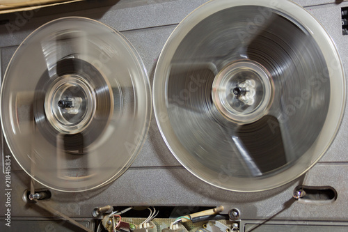 Old reel-to-reel recorder with magnetic tape on it