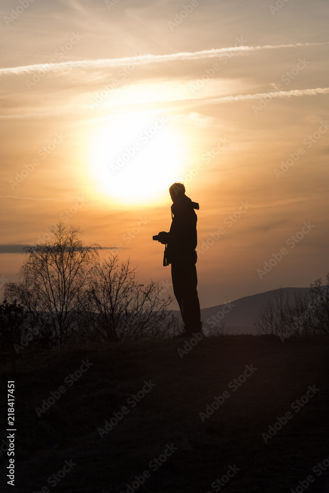 Silhouette of human during sunset. Autumn nature.