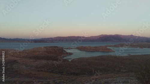 Lake in desert at sunset