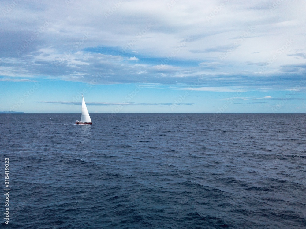 Fototapeta premium Sailing Boat in the sea with bright blue sky