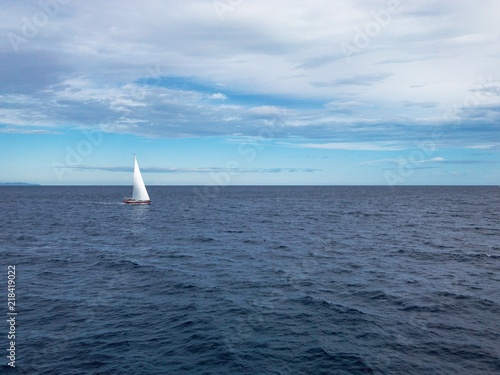 Sailing Boat in the sea with bright blue sky