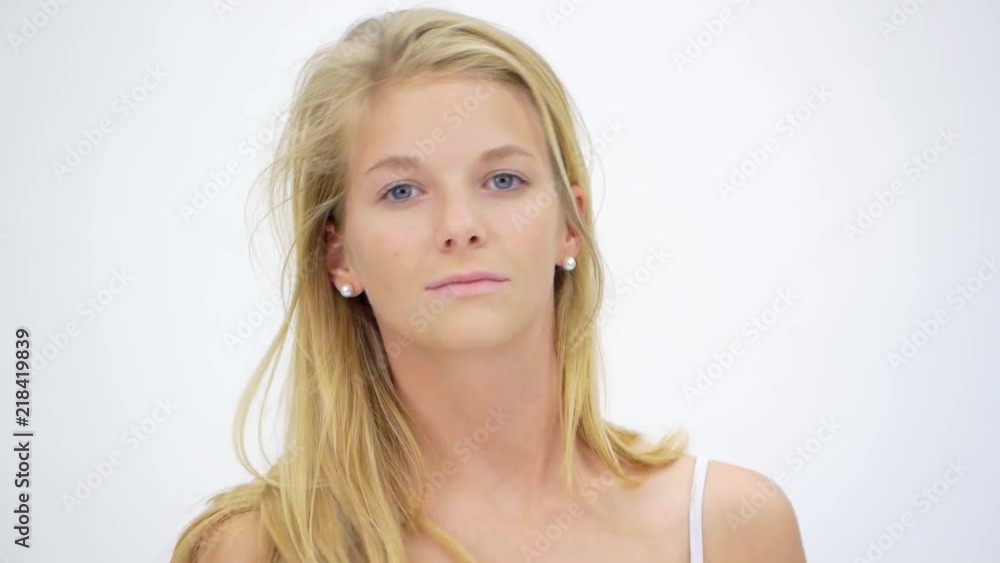 Young Girl Posing Near White Wall In Studio Young Girl Posing Near White Wall In Studio