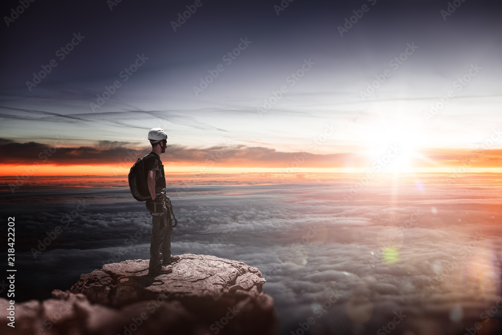 Man with a backpack on a mountain summit