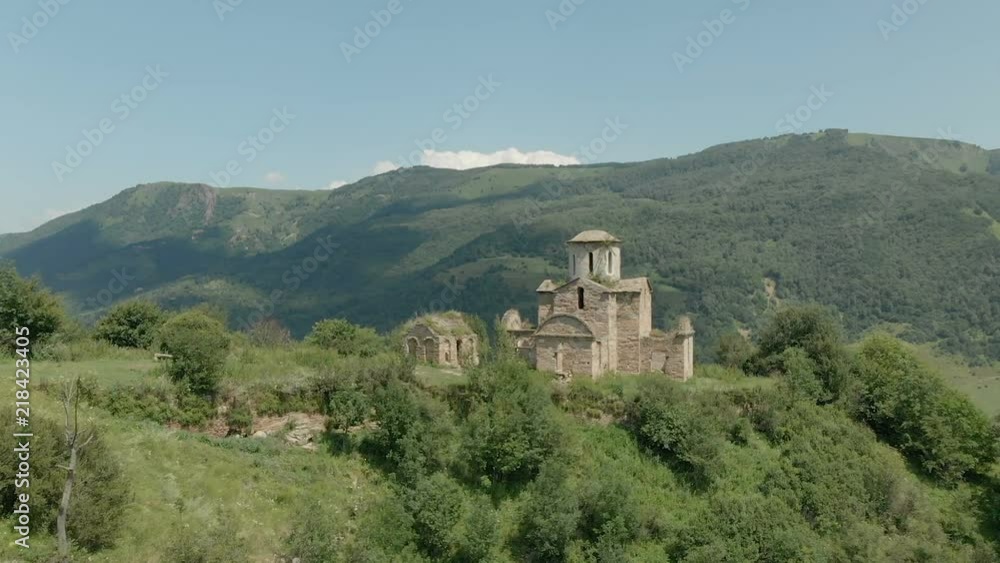 Departure on a drone from the ancient dilapidated Christian church standing high on the mountain. Aerial View. North Caucasus. Russia Departure on a drone from the ancient dilapidated Christian church standing high on the mountain. Aerial View. North Caucasus. Russia