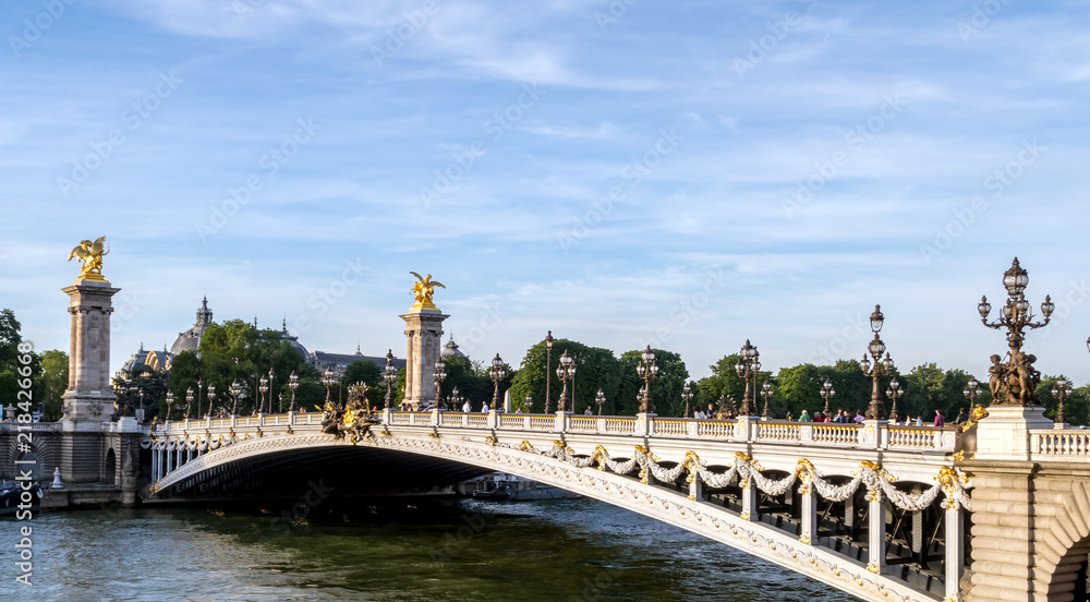 Pont Alexandre III on Seine River with Petit Palais in background - Paris France