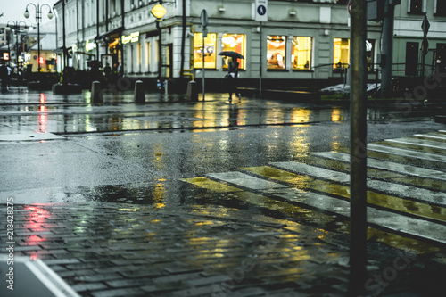 macro shot of wet city street floor cobblestone during the rain in europe