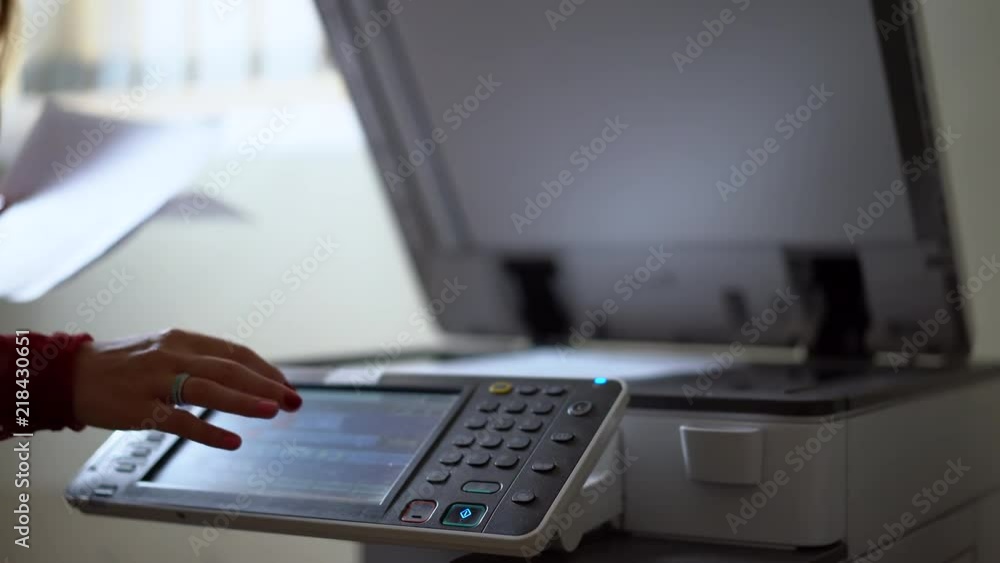 Beautiful secretary making copies in office. Professional manager working with documents and papers using print machine at her job. Shot in 4K (UHD). Beautiful secretary making copies in office. Professional manager working with documents and papers using print machine at her job. Shot in 4K (UHD).