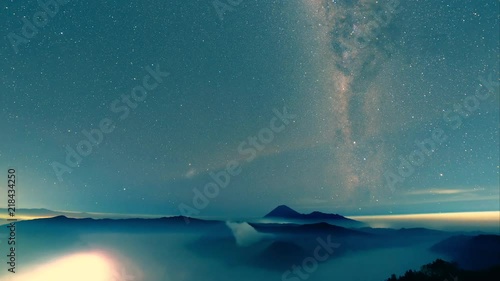 Milkyway galaxy moving from left to right over misty Bromo-Tengger-Semeru National Park a time-lapse video clip
