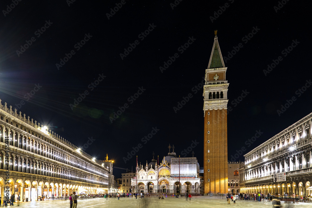 Night scenery of St. Mark's Square; Piazza San Marco, Campanile di San Marco; St Mark's Campanile and Saint Mark's Basilica; Basilica di San Marco in Venice, Italy with long exposure and flare light.