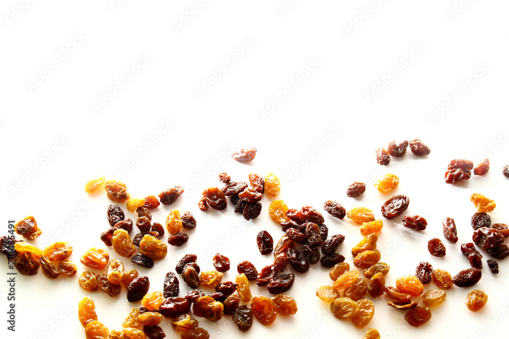 Raisins background / A raisin is a dried grape. Raisins are produced in many regions of the world and may be eaten raw or used in cooking, baking, and brewing. Raisins background / A raisin is a dried grape. Raisins are produced in many regions of the world and may be eaten raw or used in cooking, baking, and brewing.