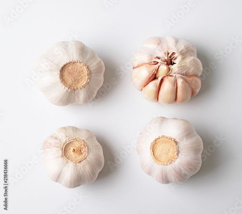 Modern layout of garlics with segments isolated on white background.