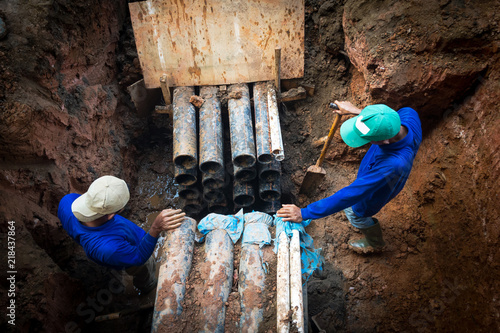 A man working to install or repair electric lines, 