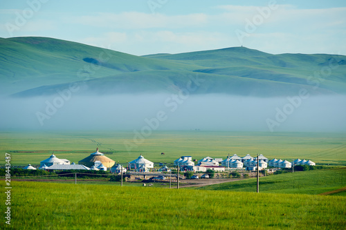 The mongolian yurts in summer grassland sunrise.