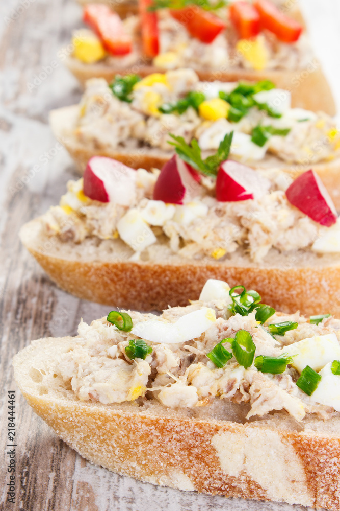 Closeup of crusty baguette with mackerel or tuna fish paste, healthy nutrition Closeup of crusty baguette with mackerel or tuna fish paste, healthy nutrition