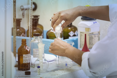 Senior researcher carrying out scientific research in a lab.Female scientist using test tube liquid sample substance probe in the scientific chemical research laboratory