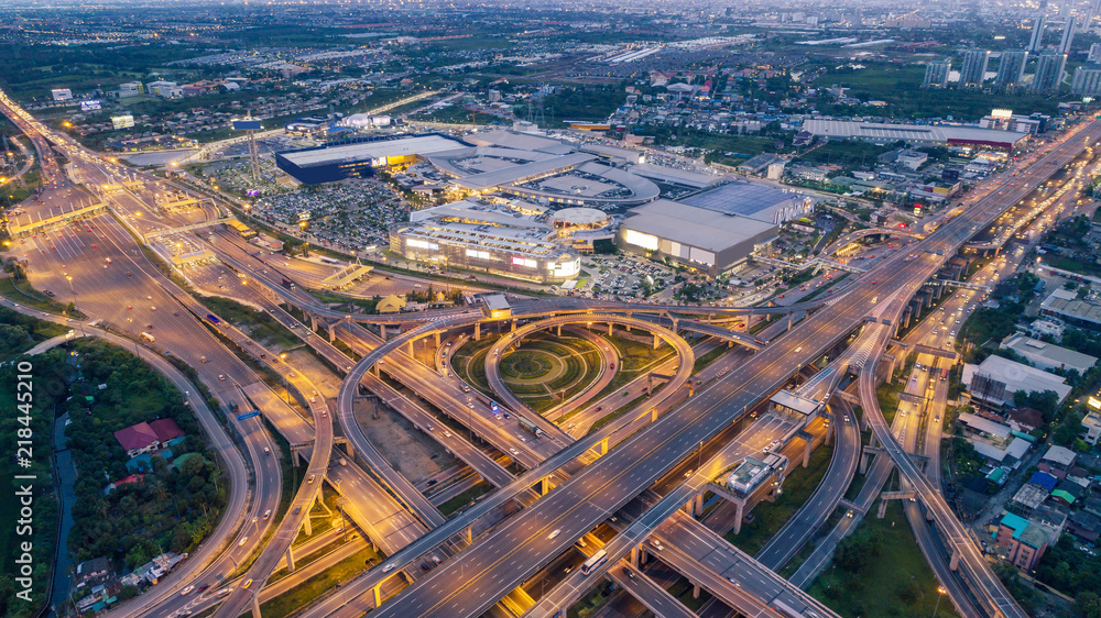 Aerial view highway road intersection at dusk for transportation, distribution or traffic background.