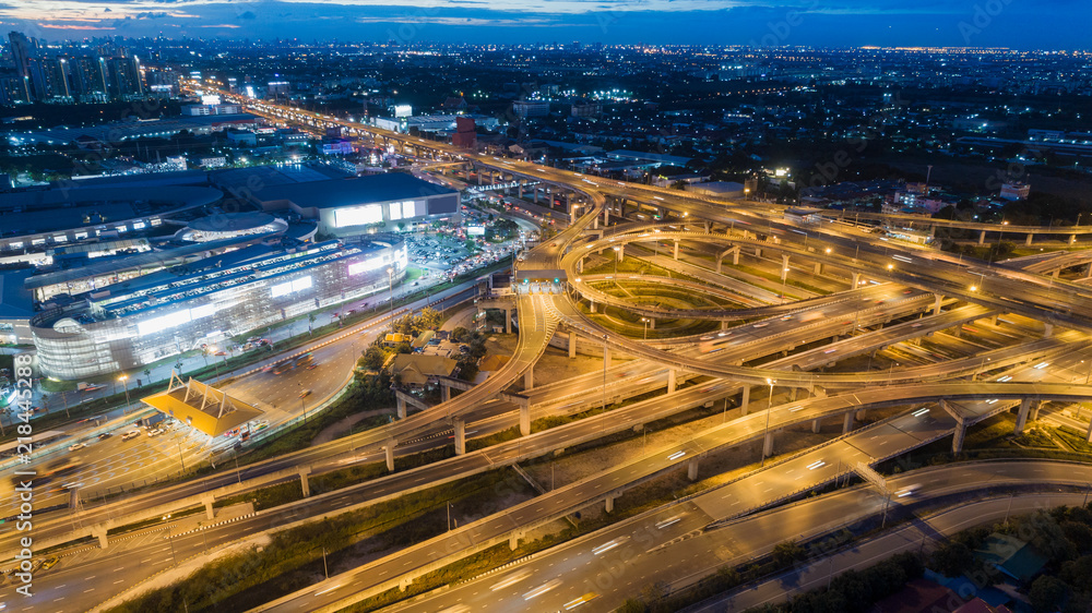 Aerial view highway road intersection at dusk for transportation, distribution or traffic background. Aerial view highway road intersection at dusk for transportation, distribution or traffic background.