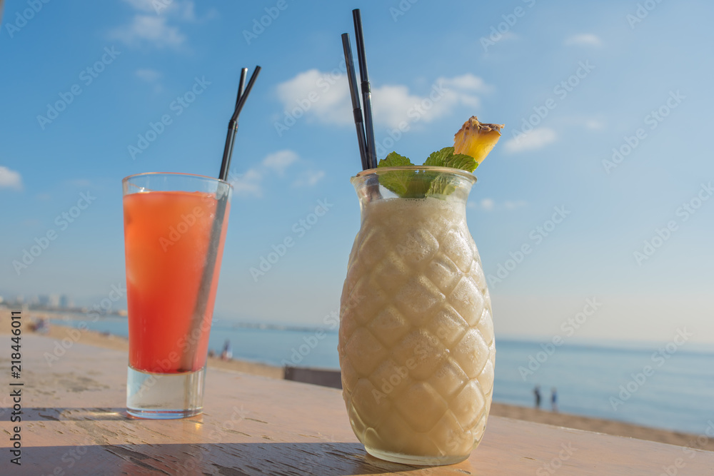 A pina colada on the bar at a beach in Barcelona, Spain. Concept of a  blissful beach vacation and getting away from it all. Stock Photo | Adobe  Stock