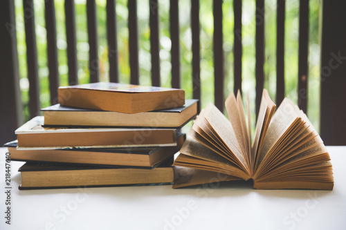 Open book on desk in the library room near window with blurred focus for background, education back to school concept